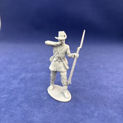 Soldier in hardee hat tearing cartridge in long jacket and kepi, mutton chop sideburns Mustache