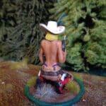 Topless woman on knees holding revolver photo review