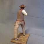 Cowboy aiming with rifle photo review