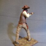 Cowboy aiming with rifle photo review