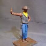 Cowboy leaning hand on wall photo review