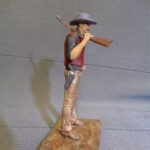Cowboy with rifle over shoulder photo review