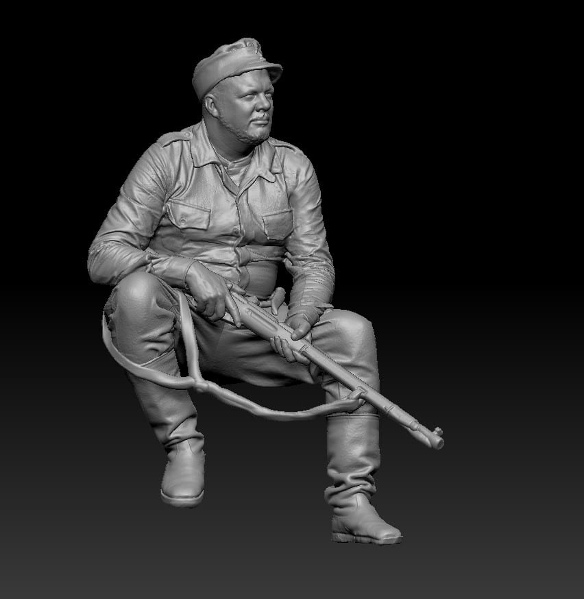 Finnish WWII soldier sitting with rifle and waiting
