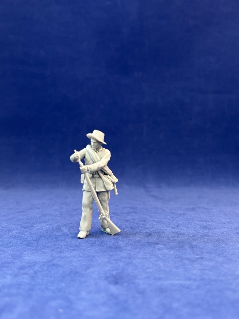Confederate Civil War soldier loading behind wall